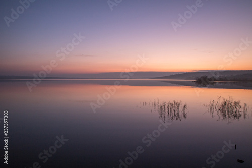 morning orange sky reflection in the lake stil water