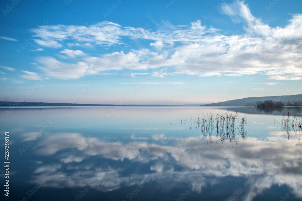 blue sky and clouds reflection in the lake stil water blue sky and clouds reflection in the lake stil water
