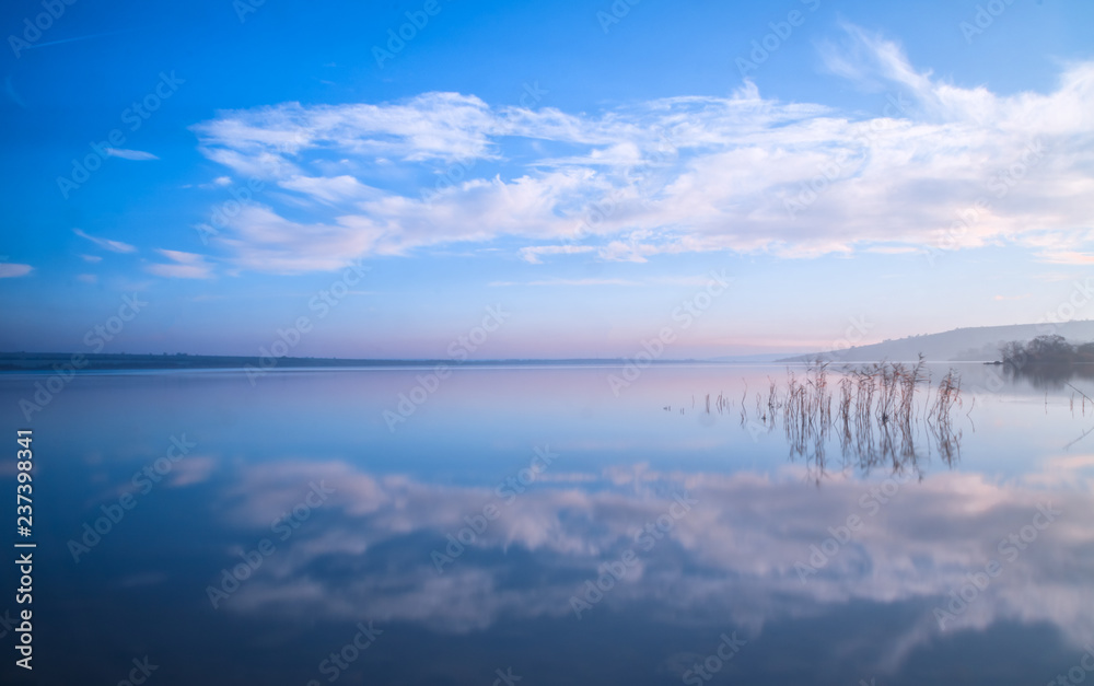 blue sky and clouds reflection in the lake stil water