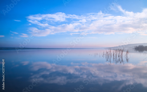 blue sky and clouds reflection in the lake stil water