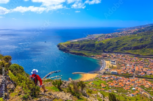 Tourist enjoying the top view of Cristiano Ronaldo airport and Machico bay region in Madeira island,