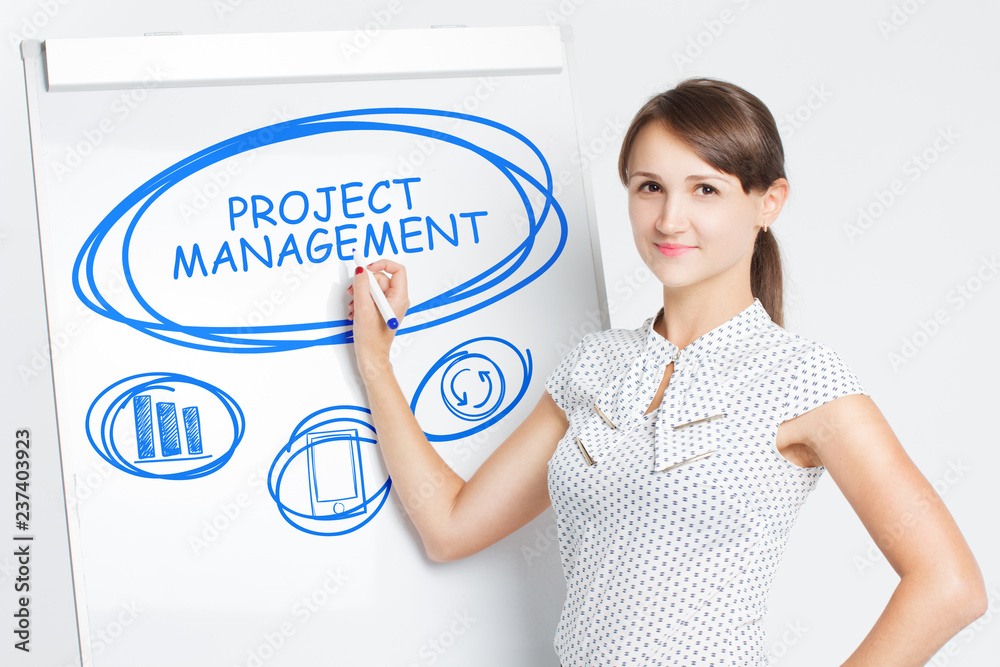 Business, Technology, Internet and network concept. A young entrepreneur writes on the blackboard the word: Project management Business, Technology, Internet and network concept. A young entrepreneur writes on the blackboard the word: Project management