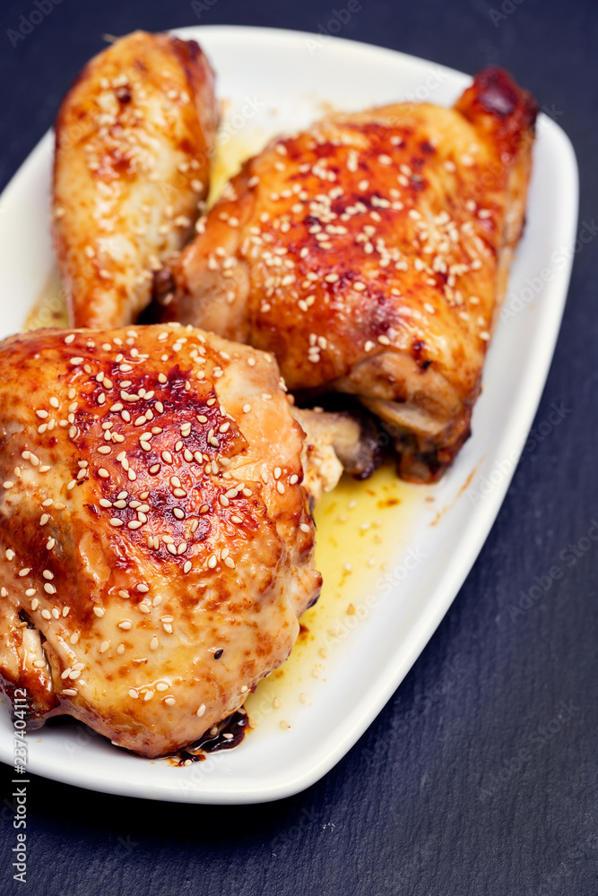 fried chicken with sauce and sesame on white dish fried chicken with sauce and sesame on white dish