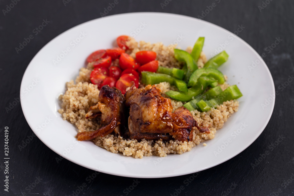 quinoa with chicken and vegetables on white plate