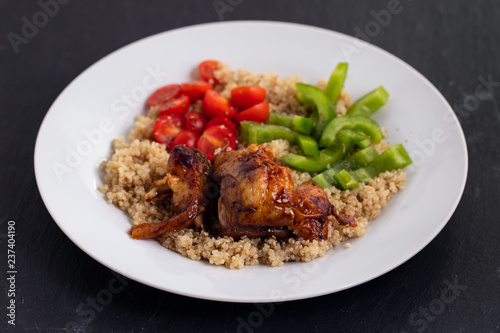quinoa with chicken and vegetables on white plate