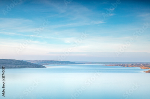 blue sky and clouds, blue lake stil water, panoramic view from high