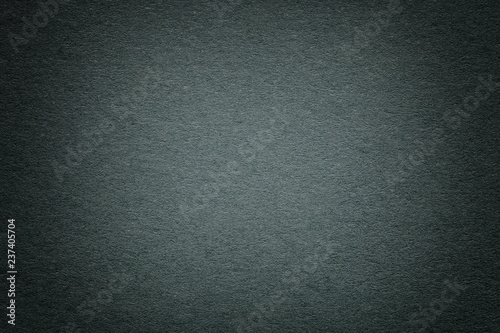 Texture of old dark green paper background, closeup. Structure of dense deep bluish cardboard.