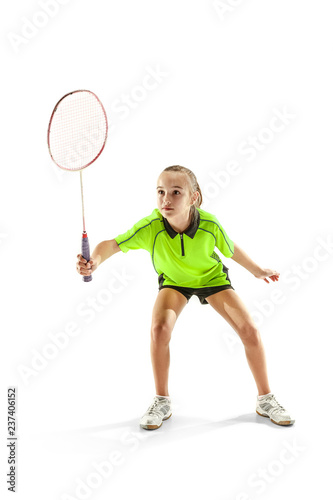 The one caucasian young teenager girl playing badminton at studio. The female teen player isolated on white background in motion © master1305