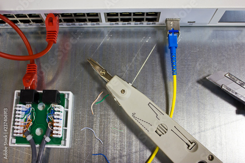 connection of a network cable with RJ45 connectors using a punching tool, the process of laying a local network