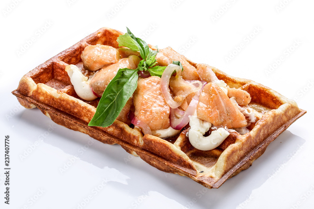 Belgian waffle on a white background. Stuffed salmon with sauce
