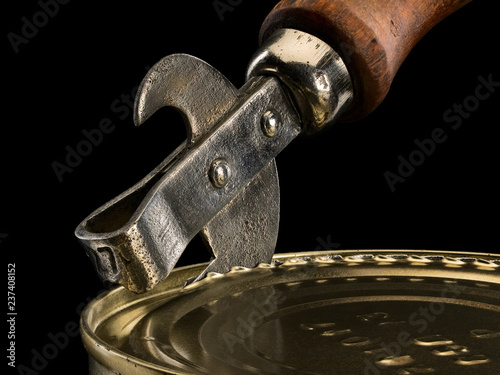 Opening of tin can by an old can opener