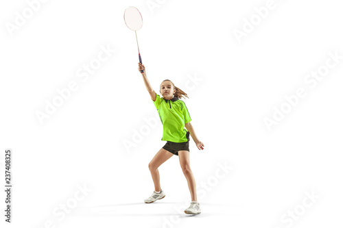 The one caucasian young teenager girl playing badminton at studio. The female teen player isolated on white background in motion
