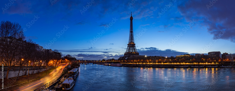 Eiffel Tower and  Seine River banks in early morning light. Panoramic view in Paris, France