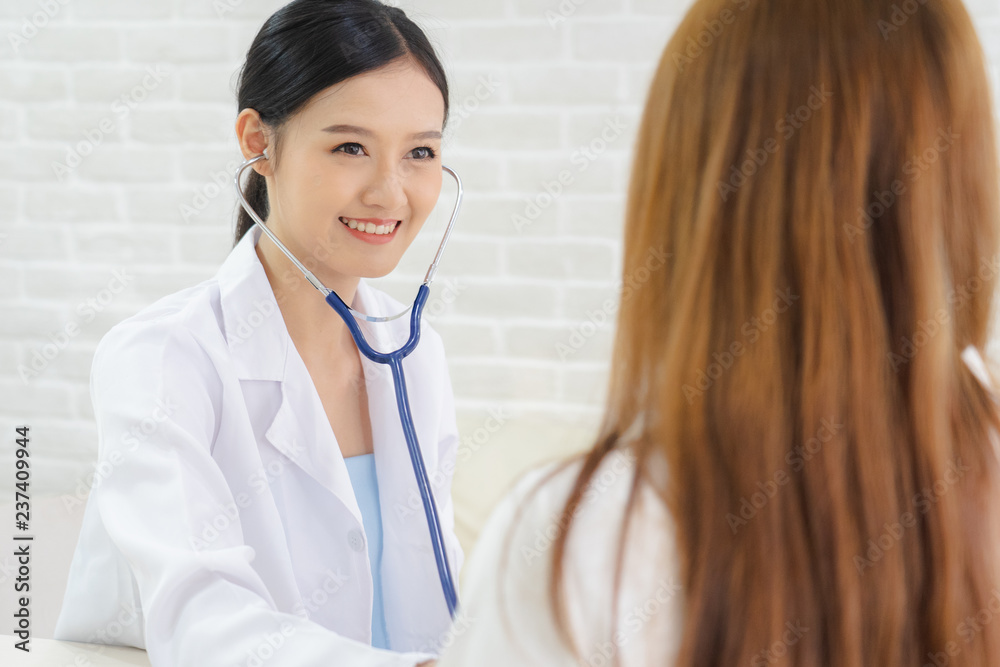 Female doctor talking to patient.Doctor and patient discussing something while sitting at the table . Medicine and health care concept. Doctor and patient Female doctor talking to patient.Doctor and patient discussing something while sitting at the table . Medicine and health care concept. Doctor and patient