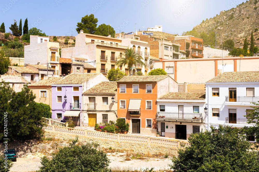 Facades of colorful houses of the Spanish old town built in the mountains.