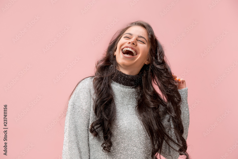 Happy business woman standing and smiling isolated on pink studio background. Beautiful female half-length portrait. Young emotional woman. The human emotions, facial expression concept. Happy business woman standing and smiling isolated on pink studio background. Beautiful female half-length portrait. Young emotional woman. The human emotions, facial expression concept.