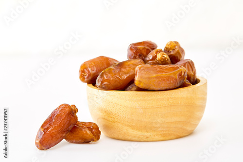 Bowl of dried dates on white