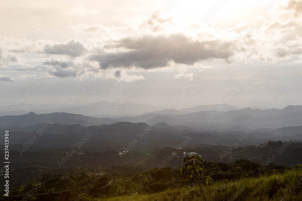 Naklejka premium Sunset at a moountain range in the central part of Panama looking towards a small mountain village