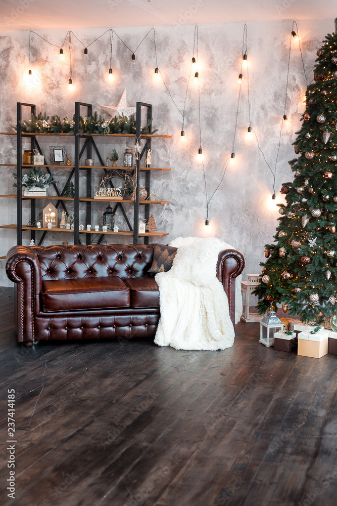 Christmas or New Year background: lamps, green cristmas tee, brown sofa, gifts Christmas or New Year background: lamps, green cristmas tee, brown sofa, gifts