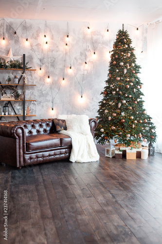 Christmas or New Year background: lamps, green cristmas tee, brown sofa, gifts