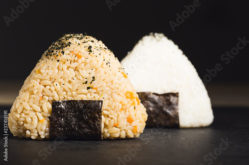 Two onigiri sushi of yellow and white rise