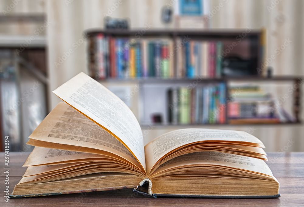 expanded book, blurred background bookshelf expanded book, blurred background bookshelf