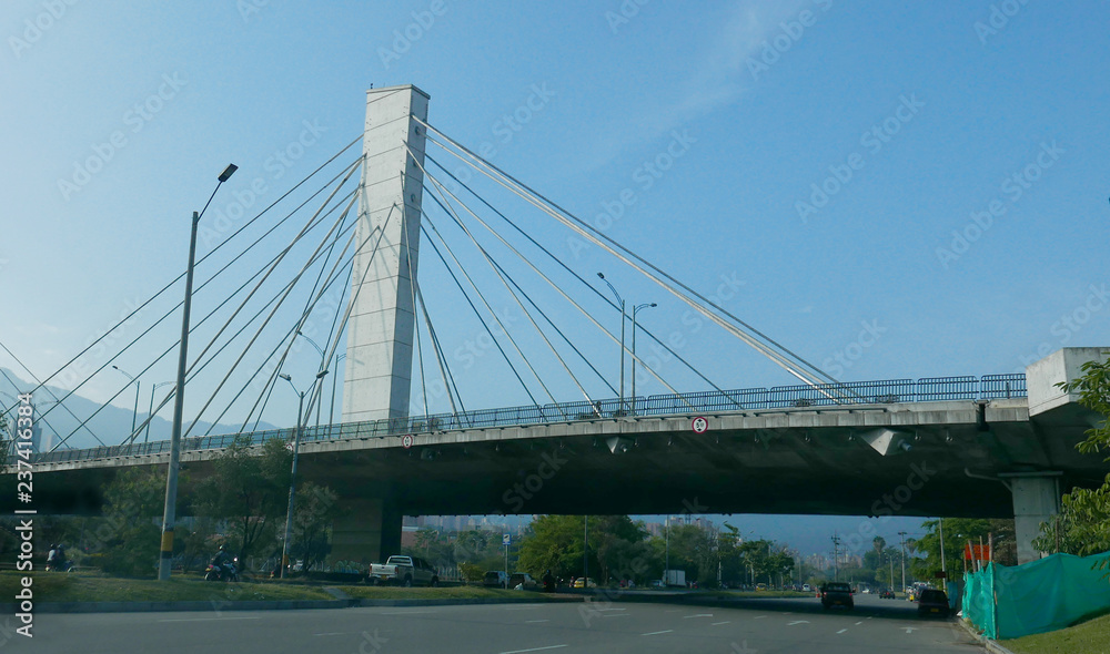 El Poblado and suspension bridge over Medellin river in Medellin, Colombia