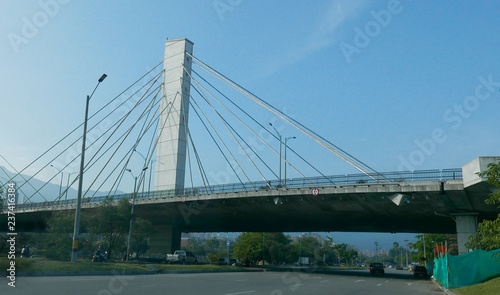 El Poblado and suspension bridge over Medellin river in Medellin, Colombia