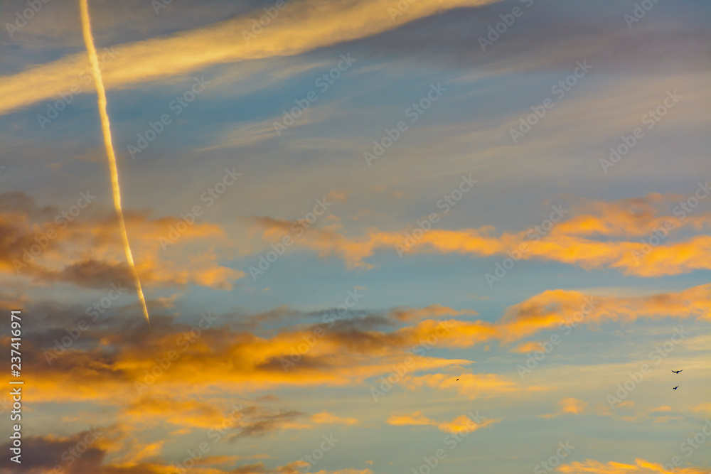 Bright morning orange sky. Footprints in the sky from the plane. Bright morning orange sky. Footprints in the sky from the plane.