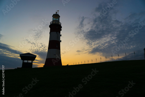 Looking up at Smeaton’s Tower, Lighthouse, Hoe Park in Plymouth with sunset background photo