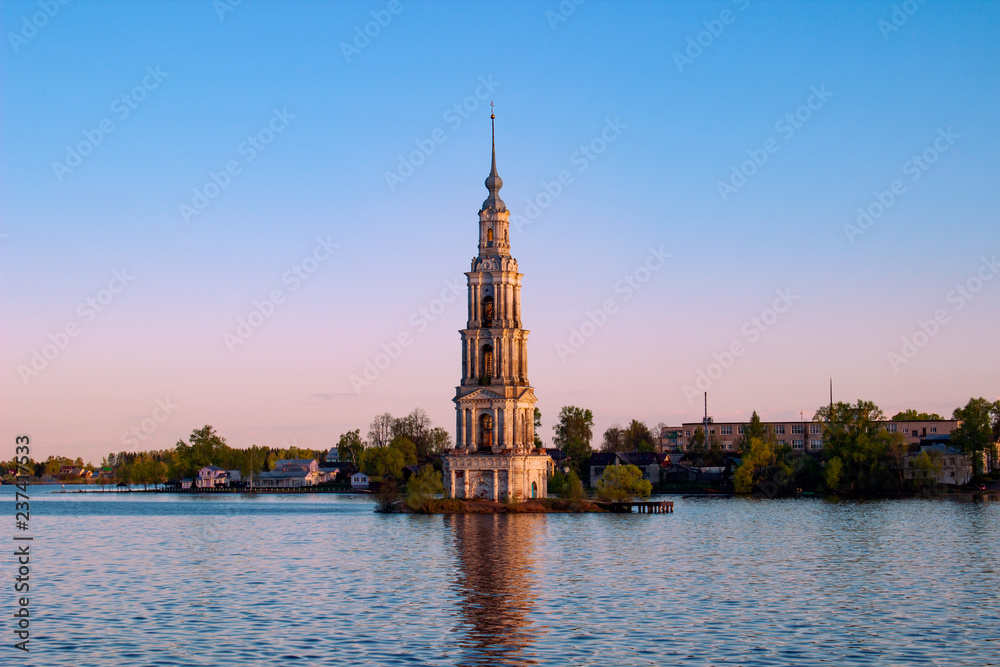 Bell tower in the water at sunset on the Volga River, Russia