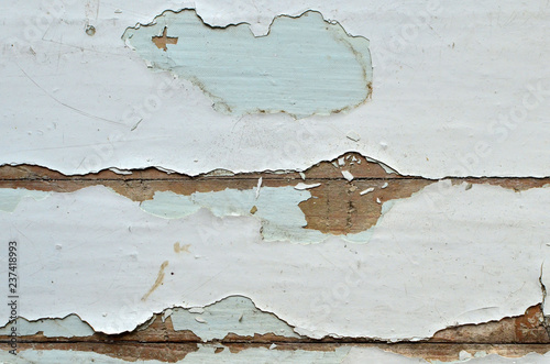 Old shabby, breakaway white paint from the wooden structure in the apartment. Old paint layers photo