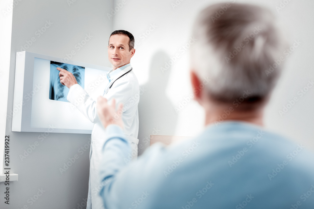 Competent physician demonstrating X-ray picture Competent physician demonstrating X-ray picture