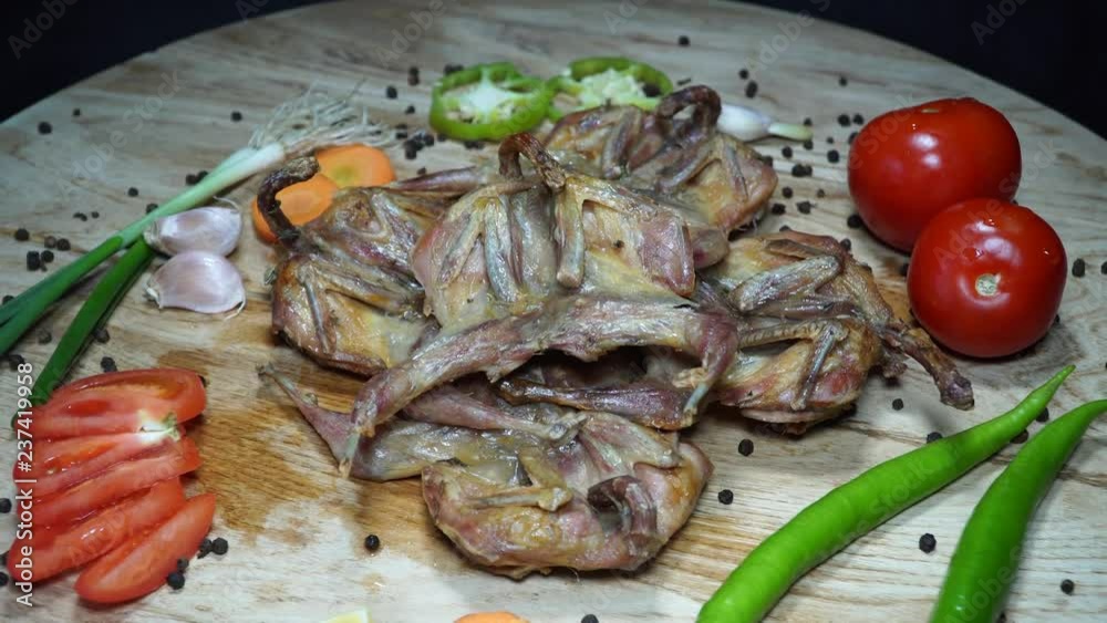 Fried quail with vegetables. Rotating on wooden table. 4K Fried quail with vegetables. Rotating on wooden table. 4K