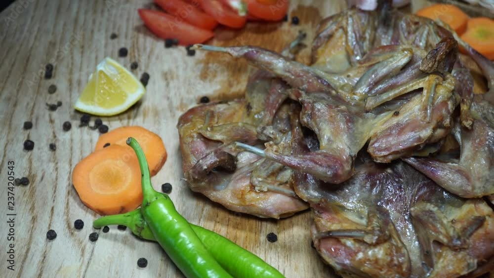 Fried quail with vegetables. Rotating on wooden table. 4K Fried quail with vegetables. Rotating on wooden table. 4K
