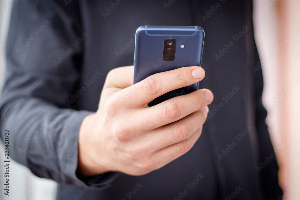 lifestyle young man using a mobile phone with texting message on app smartphone, playing social network and shopping online lifestyle young man using a mobile phone with texting message on app smartphone, playing social network and shopping online