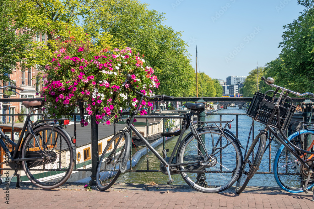 Bridge over canal with bicycles and flowers, Amsterdam, the Nethelands