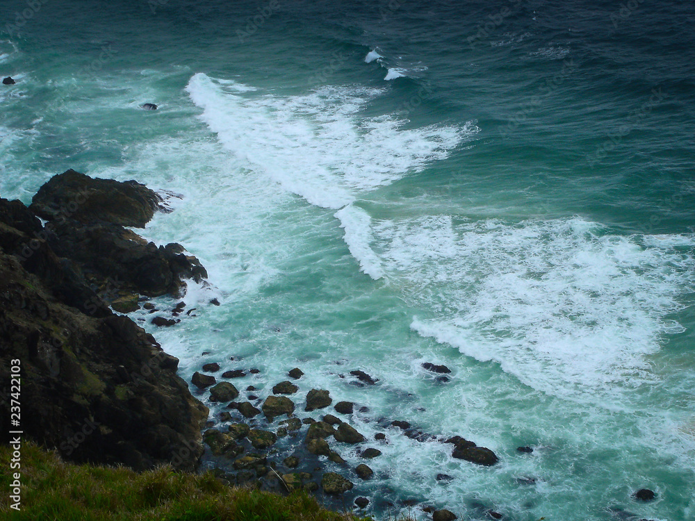 The waves splashing on the rocks