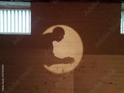 shadow of man on a wall with window