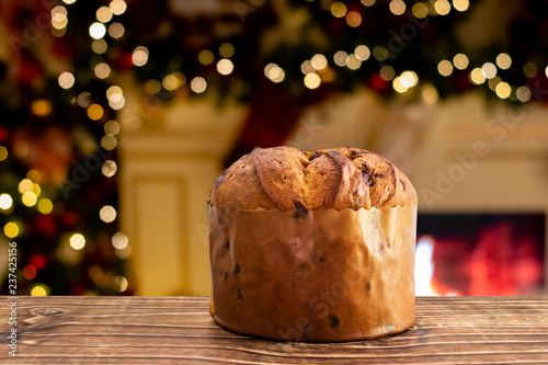 Delicious chocolate panettone with blurred christmas background photo