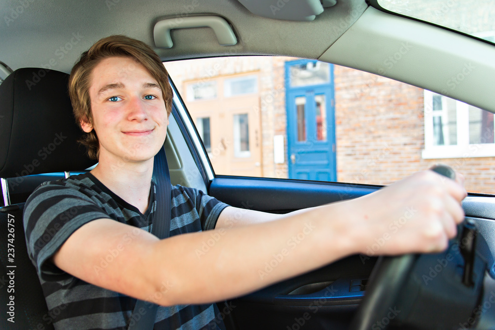 A Teenage boy and new driver behind wheel of his car Stock Photo ...