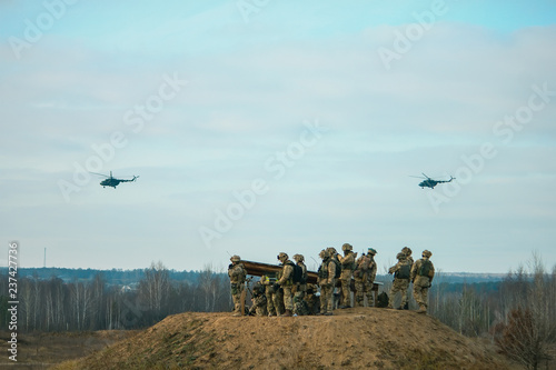 military army helicopters flying above military field