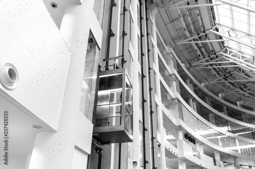 Glass Elevator in office building in black and white color, elevators to success.