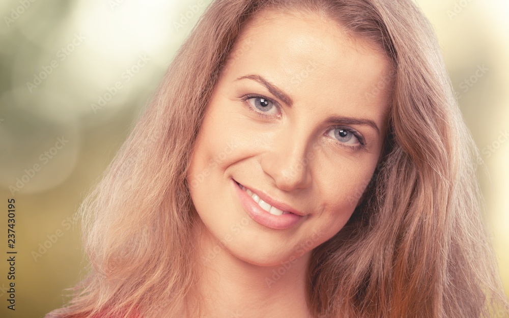 Fototapeta premium Young woman on field under sunset light