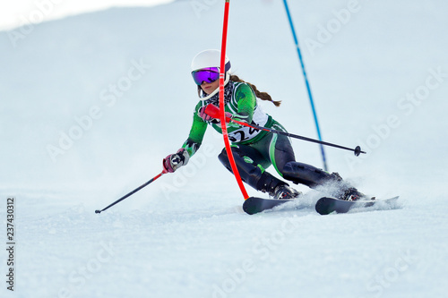 An alpine skier racing on the slalom course. photo