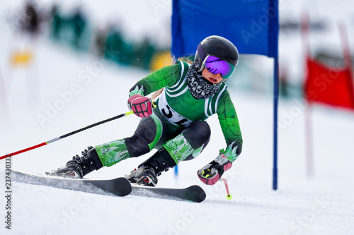 A giant slalom skier rounding a gate during a race.