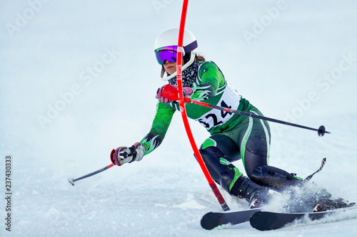 Obraz na płótnie An alpine skier punching a gate during a slalom race.