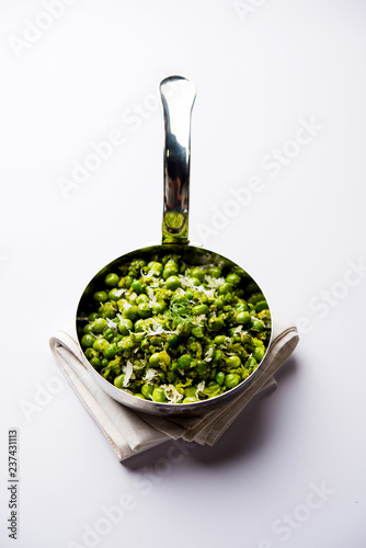 Green peas dry recipe or matar ki sookhi sabji, served in a serving pan or terracotta bowl. Selective focus photo