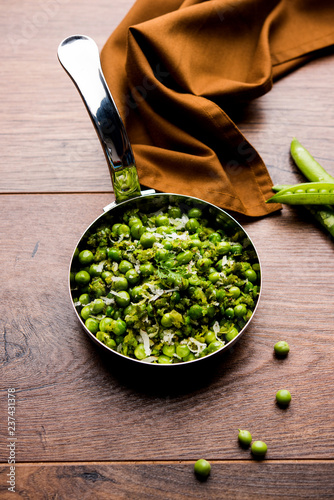 Green peas dry recipe or matar ki sookhi sabji, served in a serving pan or terracotta bowl. Selective focus