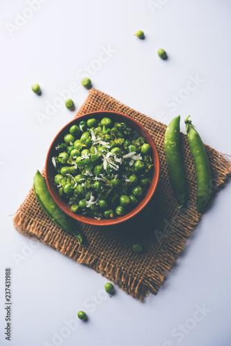 Green peas dry recipe or matar ki sookhi sabji, served in a serving pan or terracotta bowl. Selective focus photo